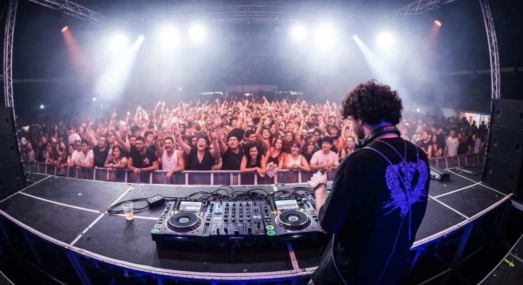 DJ performing at a lively event in Penrith with colorful lights and an engaged crowd