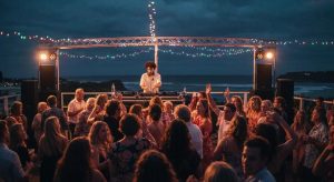Dynamic DJ performance at a vibrant Kiama event, guests dancing under colourful lights